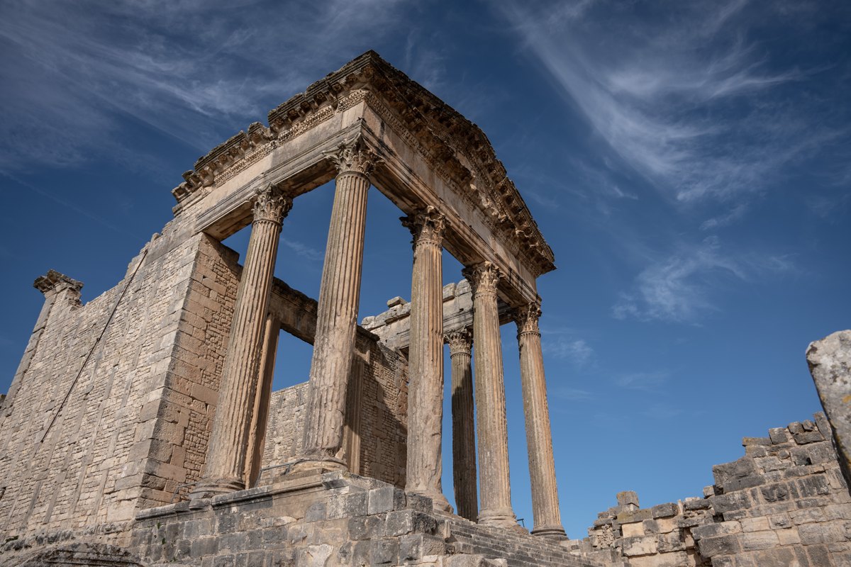 The Roman Capitol of Dougga against a streaked blue sky, Tunisia — photograph by Zied Mnif
