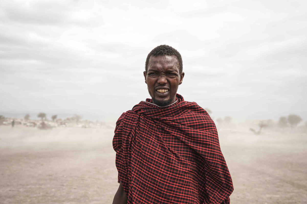 Maasai herder facing the camera through a dust storm — photograph by Zied Mnif